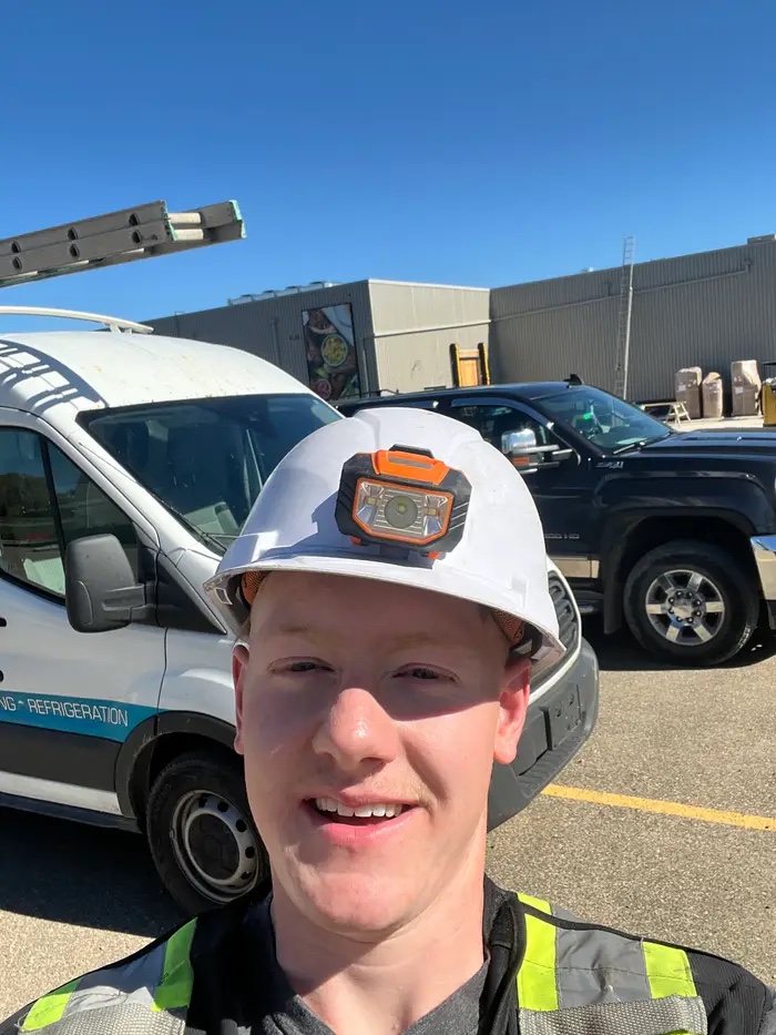 Teagan Trapp in a hard hat working his commercial HVAC job